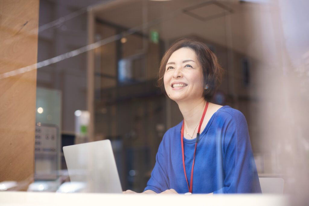 woman in blue shirt working on a computer